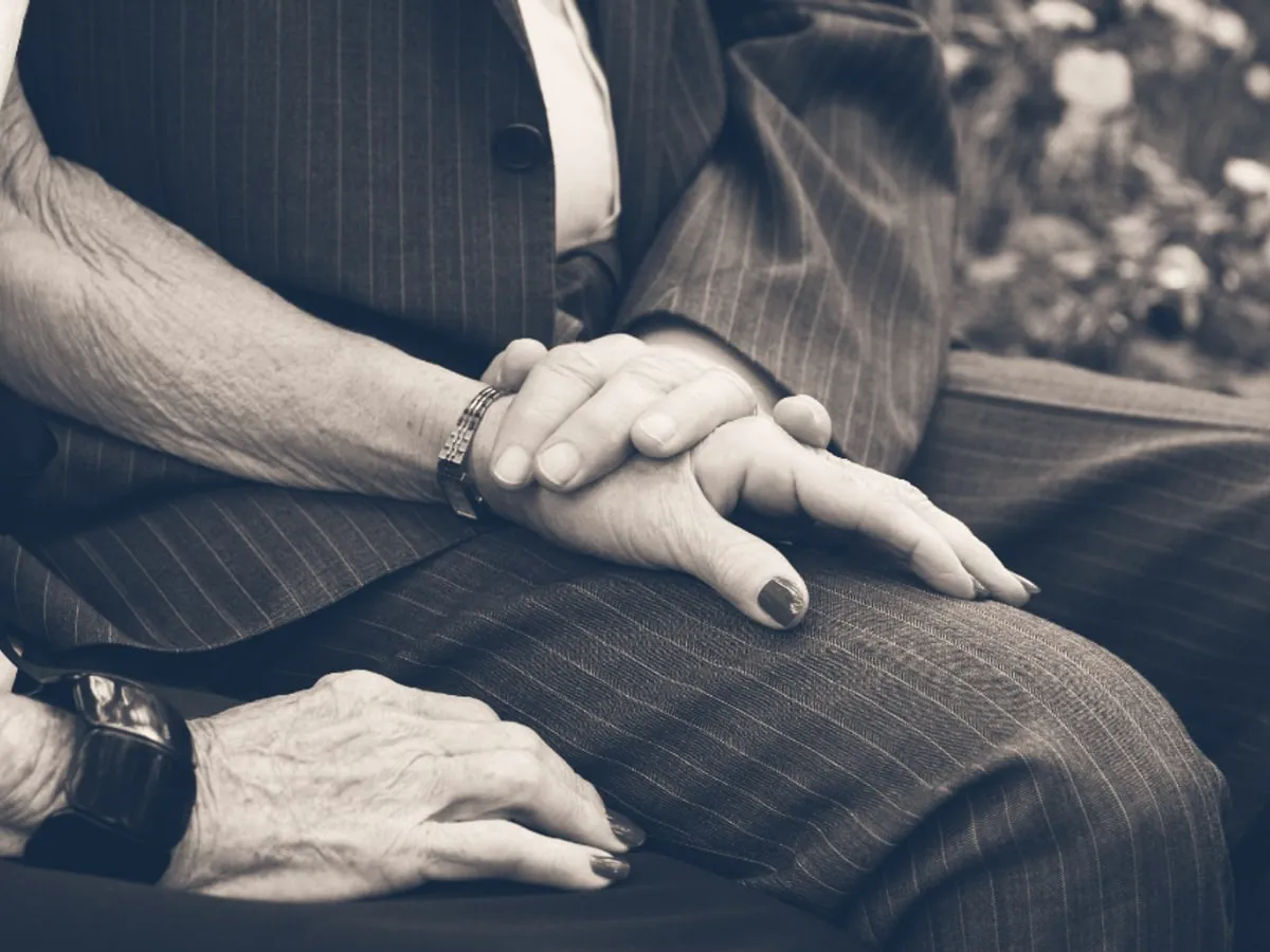 A pair of hands resting quietly, one over the other